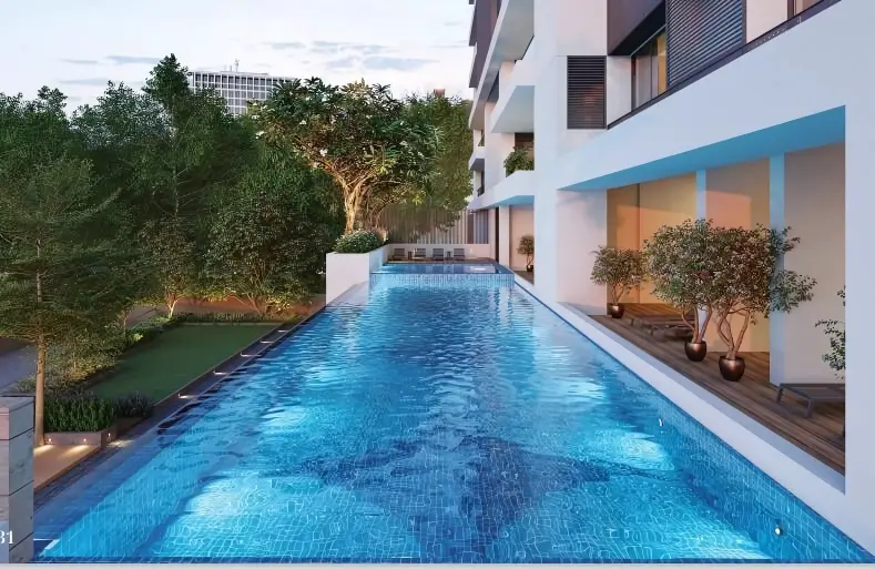 An emerald pool deck wrapped in greenery.